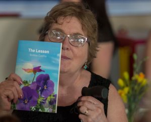 photo of Bobbie Coelho holding up one of her books